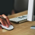 Person using computer mouse at desk