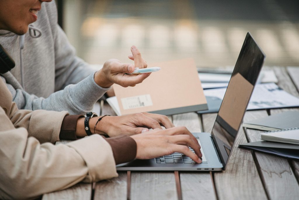 two people using a laptop